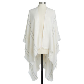 A cream striped poncho with a short fringe displayed on a mannequin.