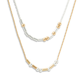 Silver and gold necklace with rods and beads spelling out morse code with the theme of kindness.