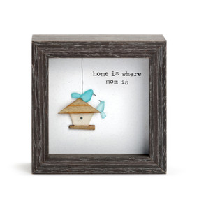A square dark wood shadow box with a stone and wood image of a birdhouse with two blue birds that says "home is where mom is".