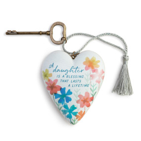Heart shaped sculpture with a silver tassel and metal key attached. The heart has colored flowers and says "A daughter is a Blessing that Lasts A Lifetime".