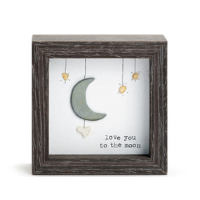 A square dark wood shadow box with a stone image of the moon and stars that says "love you to the moon".