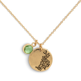 Detail view of the charms on a delicate gold necklace with a round gold charm with the birth flower for August and a separate birthstone.