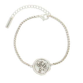A silver metal bracelet that has a round metal charm with a bunch of flowers.