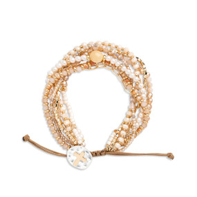An adjustable bracelet made of multiple stands of various beads all in a champagne color and a mixed metal charm with a gold cross.