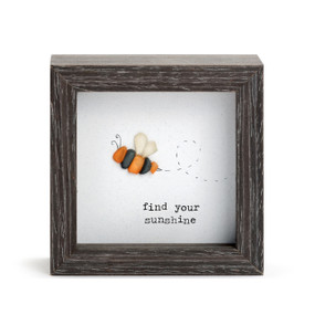 A square dark wood shadow box with a stone bumblebee that says "find your sunshine".