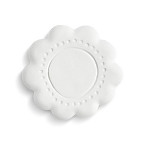 A white round flower shaped diffuser stone with the imprint of a circle and dots on top.