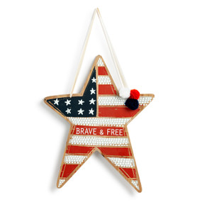 A star shaped wood door hanging decoration that looks like an American Flag and says "Brave & Free".