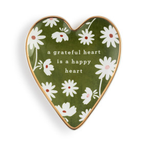 Heart shaped ceramic dish with a gold rim. The interior is green with white flowers and says "a grateful heart is a happy heart".