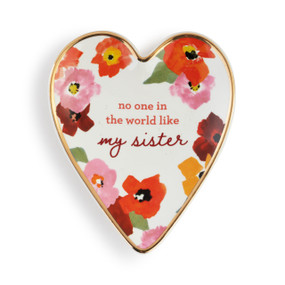 Heart shaped ceramic dish with a gold rim. The interior is bright flowers and says "no one in the world like my sister".