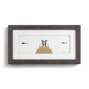 A rectangular dark wood framed wall art of a wood pier and two people at the end made out of natural elements.