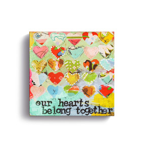 Square wall art with multicolored hearts that says "our hearts belong together".