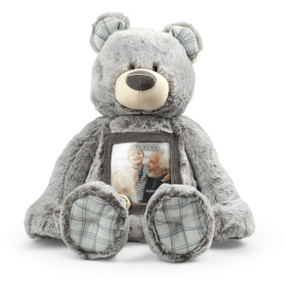 Gray plush bear with plaid ears and paws. The bear has a see through pocket on his chest to place a photo.