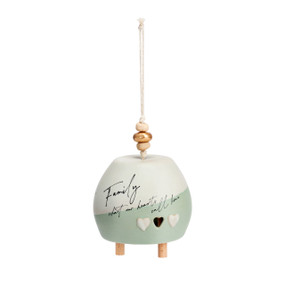 A cream and light green bell that says "Family what our hearts call home". There are beads at the top of the bell.