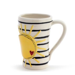 Front view of a cream handled ceramic mug with a yellow sun against black lines going around the mug.