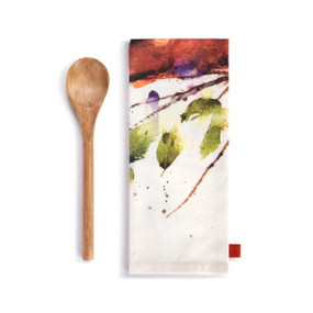 A white kitchen towel with a watercolor image of a cardinal next to a wood spoon.