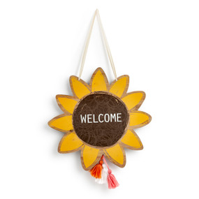 Sunflower shaped wood hanging door decoration that says "Welcome" with three colored yarn tassels at the bottom.