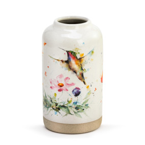 A cream stoneware vase with a hummingbird and wildflowers. The vase has a textured tan base.