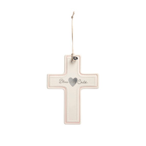 A cream ceramic hanging cross with a pink accent and says Bless this Child with a silver token at the top.