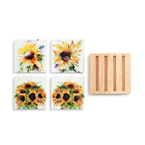 A set of four white stoneware coasters with different watercolor images of sunflowers next to a square wood holder with four slats.
