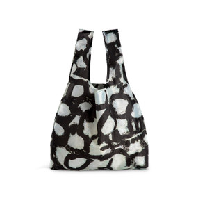 A fabric handled tote bag with artwork inspired by ArtLifting artist Linda King of a black and white geometric design.