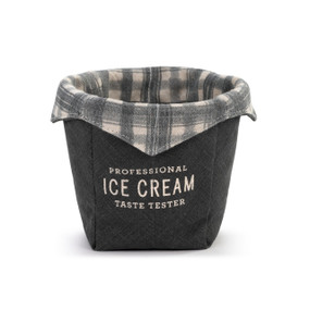A dark gray fabric ice cream cozy that says "Professional Ice Cream Taste Tester" with a gray and cream plaid fabric on the inside.