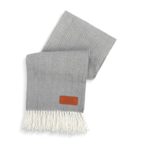 A gray and cream blanket with a brown patch at the bottom right that says "If you Love Someone Let Them Nap".
