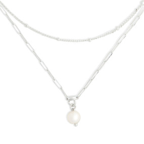 Detail view of the pearl charm on an adjustable silver chain necklace with a pearl bead at the bottom.