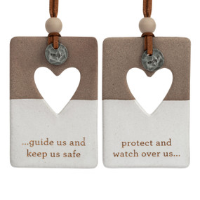 A set of two hanging tan and white ceramic ornaments with a heart cutout and metal tokens that say "angel". One ornament says "guide us and keep us safe" and the other says "protect and watch over us".