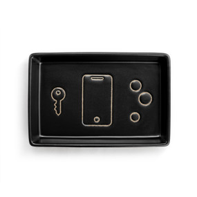 A black ceramic rectangular tray with the image of a phone, key and coins inside.