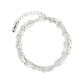 A multi-strand silver chain adjustable bracelet with small pearls attached to one of the strands.