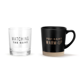 A black handled stoneware mug that says "Pre-Game Warm Up" and a clear rocks glass that says "Watching The Game".