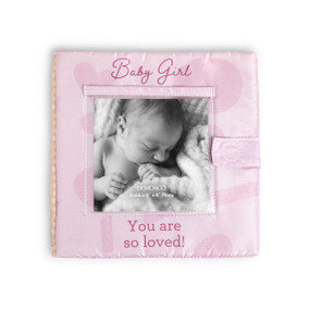 A pink fabric photo book with a holder for a photo on the front. The book says "Baby Girl You are so loved!"