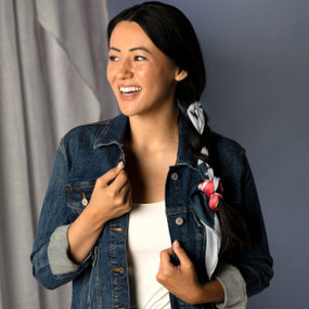 A smiling woman wearing a square neckerchief tied into her ponytail. The neckerchief has a red camellia flower on an off white background inspired by ArtLifting artist Midori.