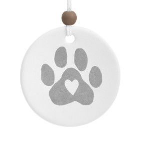 A round white ceramic hanging diffuser with a gray paw print that has a heart in the center.