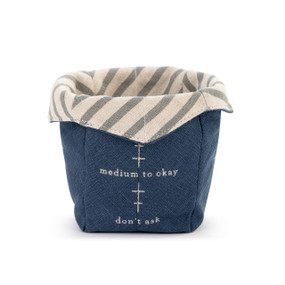 A dark blue fabric ice cream cozy that a "day meter" on it with a gray and cream striped fabric on the inside.