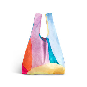 A fabric handled tote bag with artwork inspired by ArtLifting artist Christina Constantine of an abstract sunshine design in yellow, purple and blue.