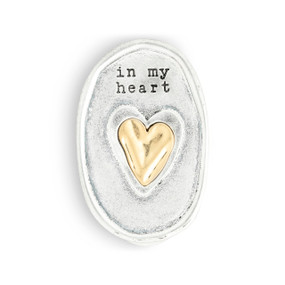 An oval silver metal visor clip with the image of a heart in gold and says "in my heart".