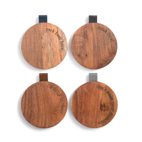 Four different round wood coasters with a beer theme and cute sayings along the edge. They each have a leather tab in a different color on the edge.