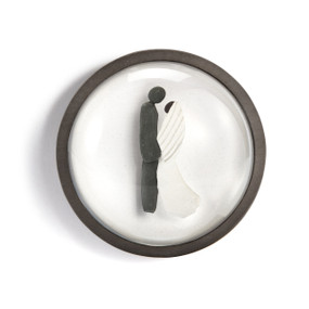 A round paperweight with a wood frame and the image of a wedding couple made of stone and pebble.