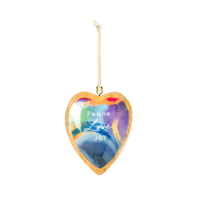 A hanging heart shaped wood ornament with a blue and purple artwork inside inspired by ArtLifting artist Yvette. The ornament says "Peace Love Joy".