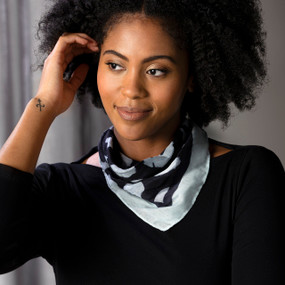 A woman wearing a black top and a neckerchief with black circles on an off white background inspired by ArtLifting artist Linda King.