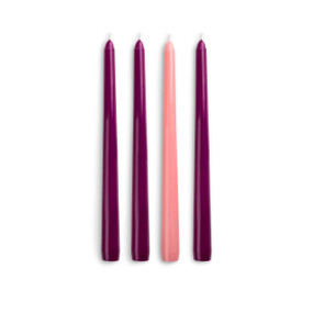 A set of four taper Advent candles with three purple and one pink.