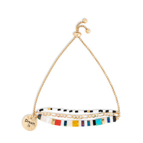 A gold chain adjustable bracelet with beads and tiles in a variety of colors and white. The bracelet also has a gold round charm that says Dream it.