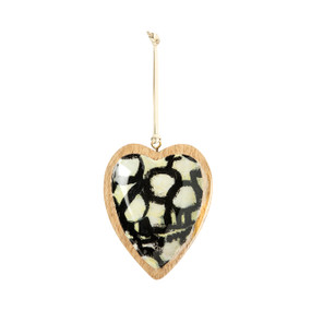 A hanging heart shaped wood ornament with a black and off white pattern artwork inside inspired by ArtLifting artist Linda King.