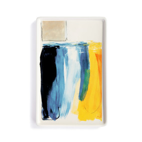 A white ceramic small tray with artwork created by ArtLifting artist Charlie French. The image is vertical shades of yellow and blue paint stripes.