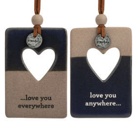 A set of two hanging tan and dark blue ceramic ornaments with a heart cutout and metal tokens that say "grandkid" and "grandma". One ornament says "love you everywhere" and the other says "love you anywhere".