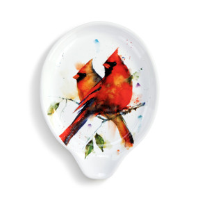 A white ceramic spoon rest with a watercolor image of a pair of cardinals.