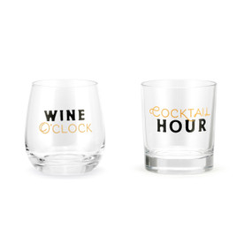 Two clear drink glasses. One is a stemless wine glass that says "Wine O'Clock" and other is a rocks glass that says "Cocktail Hour".