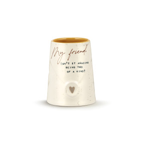 A cream stoneware vase with the texture to look like an envelope flap and has a heart where it would seal. The interior is dark yellow and the outside has a sentimental message to a friend.