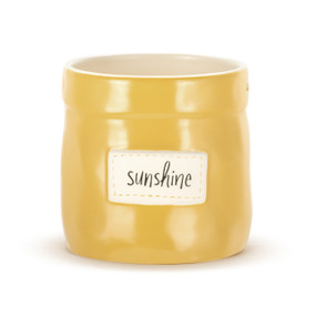 A yellow round stoneware planter with a cream interior and a cream patch on the front that says "Sunshine".